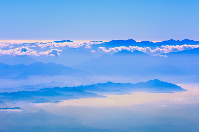 Layered Mountains with Clouds and Clear Blue Sky