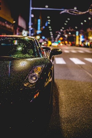 Black Lamborghini Gallardo on a Wet City Street at Night