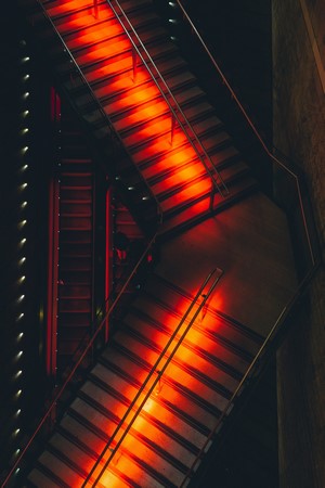 Stairs illuminated by red lights from above