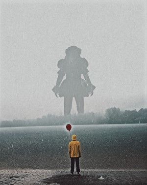 Pennywise from It holding a red balloon in the rain