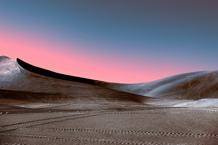Snowy dunes under a pink and blue sunset sky