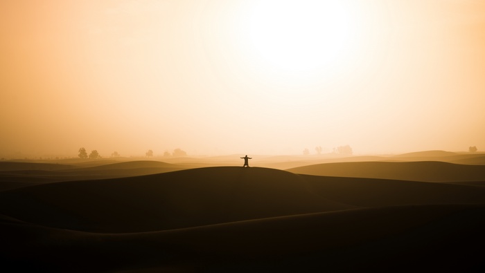Silhouette of a person in the Sahara desert at sunset