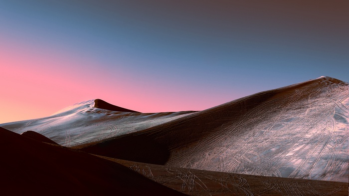 Desert dunes at sunset with pink and blue sky