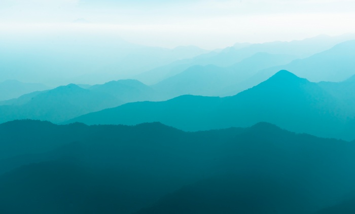 Teal and turquoise mountain range landscape
