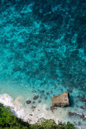 Aerial view of a rocky coastline with turquoise water