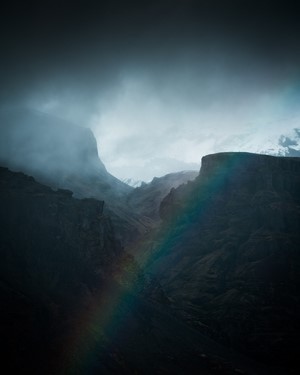 Rainbow over a misty mountain valley