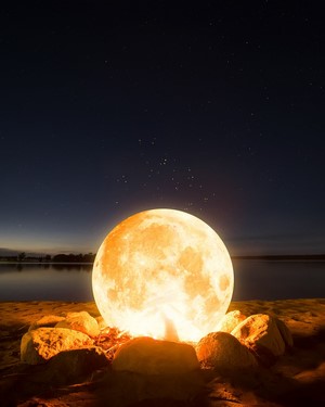 Moon over water at night