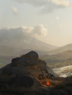 Man resting by campfire on rocks with mountains in background
