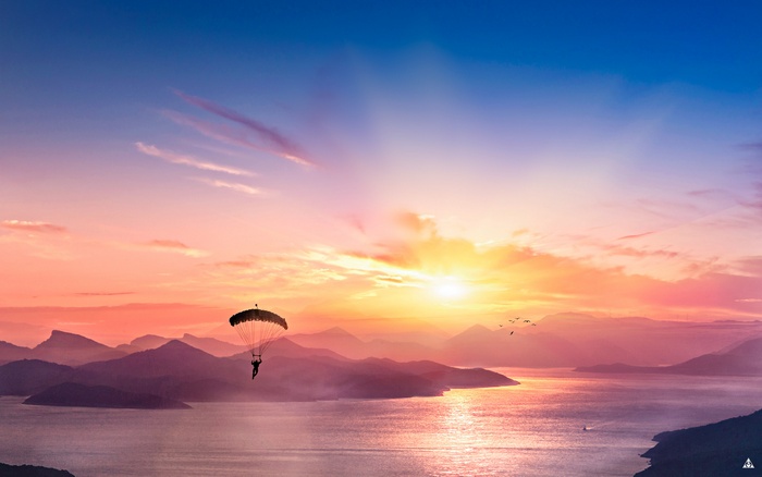 4K Parasailing over Mountains at Sunset
