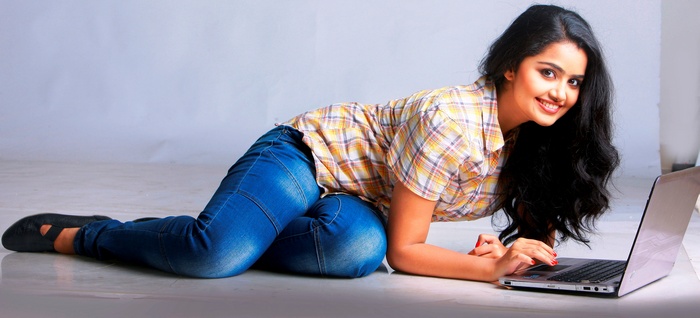 Anupama Parameswaran using a laptop