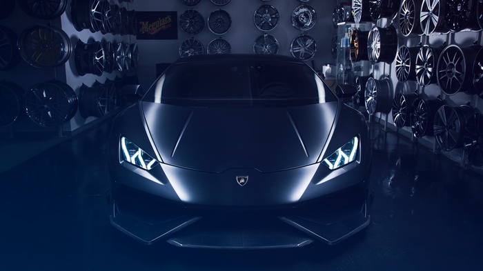 Black Lamborghini Huracan in a garage with rims