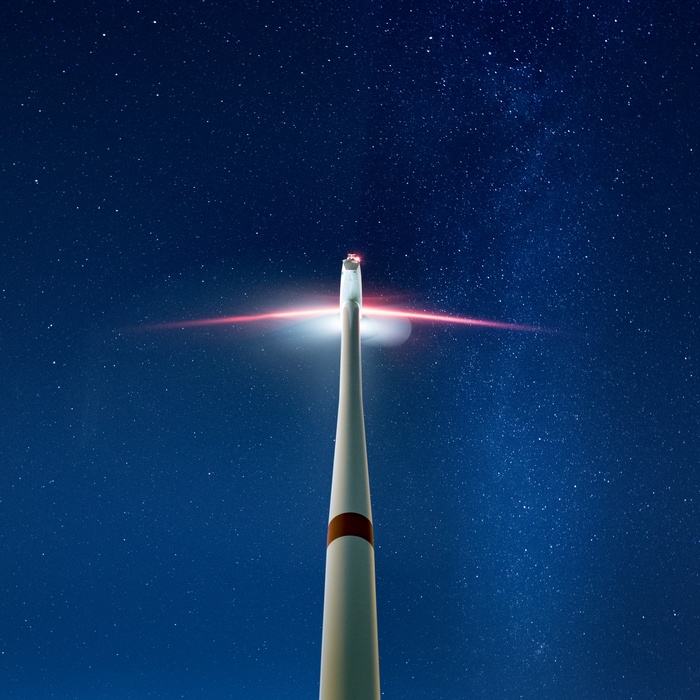 Wind turbine against a starry night sky