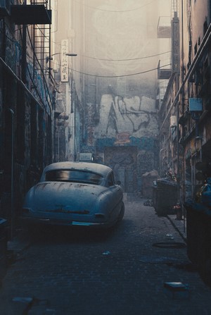 Old car in a gritty urban alleyway with graffiti