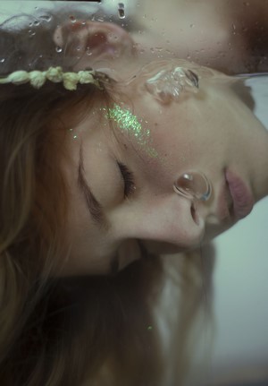 Woman underwater with glitter and bubbles