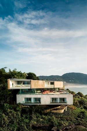Modern multi-story house on a cliff overlooking the ocean