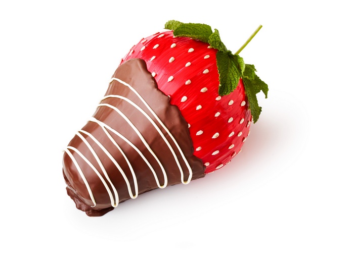 Chocolate-dipped strawberry with white drizzle and mint leaves