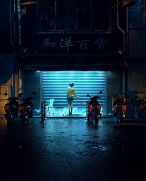 Woman in yellow jacket at night in wet alley with motorcycles