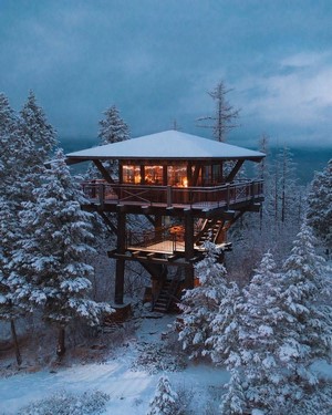 Snow-covered cabin in a winter forest
