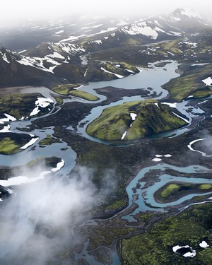 Aerial view of snow-capped mountains and glacial rivers
