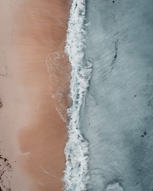 Aerial view of a sandy beach and ocean waves