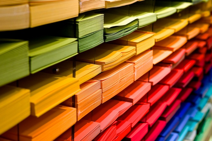 Stacks of colorful paper in a rainbow gradient