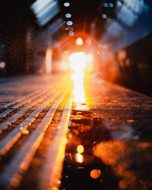 Train station platform with blurred lights and water