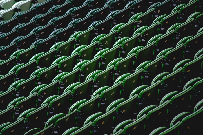 Rows of empty green stadium seats