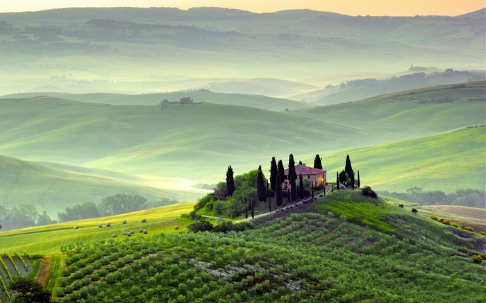 Tuscan landscape with a villa and rolling hills