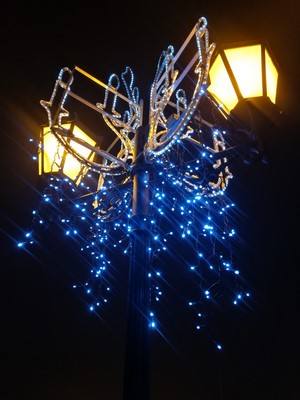 Street lamp decorated with blue and white lights