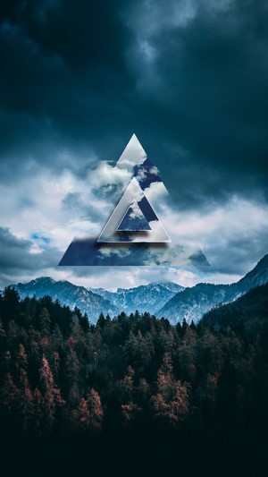 Abstract triangle over mountains and forest