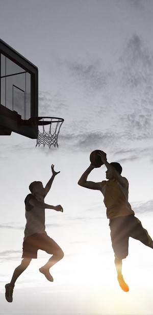 Basketball players jumping for a shot