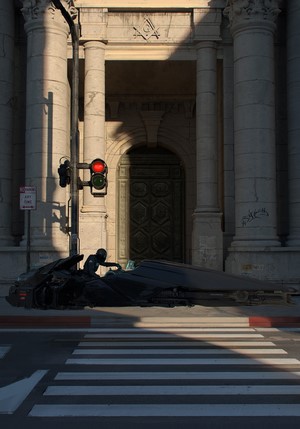 Futuristic vehicle with a person in front of a building