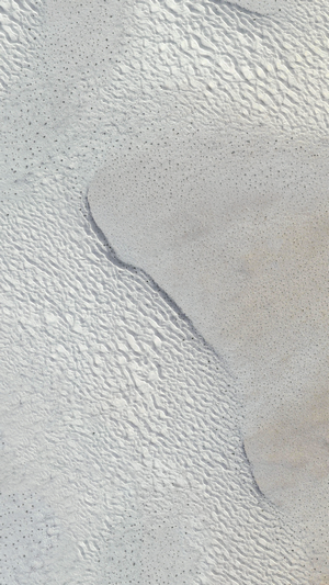 Aerial view of sand dunes with ripples