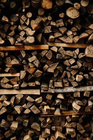 Pile of chopped firewood stacked on wooden shelves