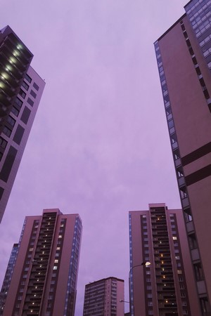 Tall apartment buildings against a purple sky