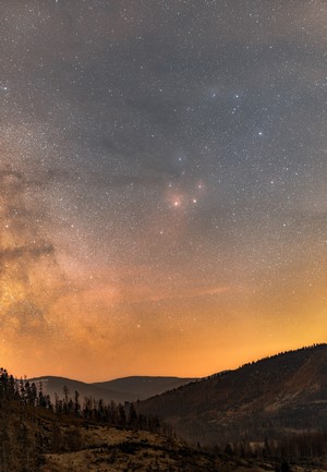 Scorpio constellation in the night sky over mountains
