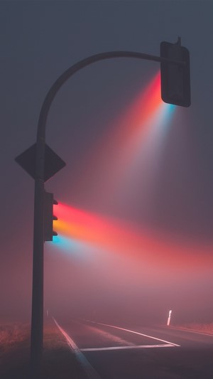 Traffic lights in fog with colorful beams