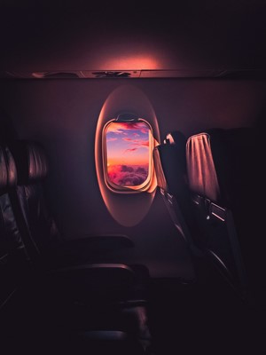 Airplane window view of sunset clouds