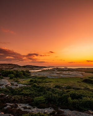 Coastal landscape at sunset with orange sky