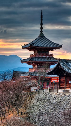 Pagoda at sunset with hills and trees