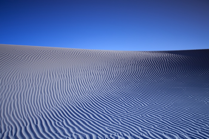 Sand dunes under a clear blue sky