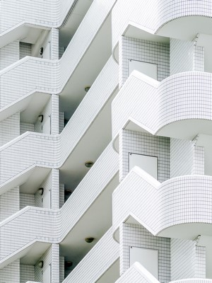 White tiled building with balconies and stairs