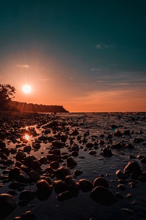 Sunset over a rocky coast with the ocean