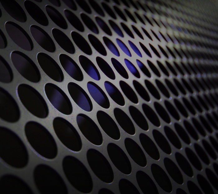 Perforated metal surface with blue light