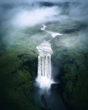 Misty Waterfall in a Green Landscape