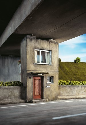 Miniature house built under a concrete bridge