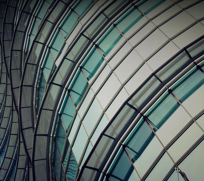 Modern glass building facade with curved lines