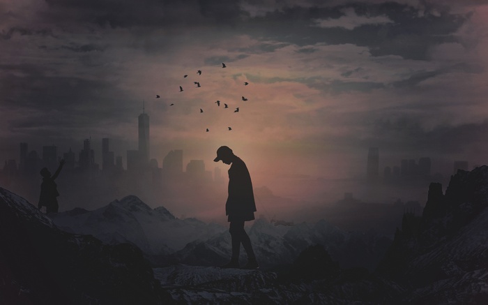 Silhouette of a man and birds at sunset with city skyline