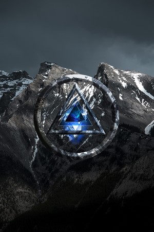 Digital art of a triangle within a circle over mountains