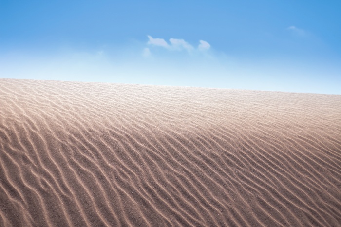 Sand dunes under a blue sky